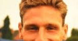 Cheerful young man with blond hair wearing a blue sports jersey, smiling confidently, ideal for "Hopeful - Tony.