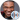 Keith David, known for his role in Spawn, smiles warmly in a stylish black and red outfit against a neutral background.