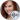 Portrait of Sara from "Unfriendly," showcasing her red hair and warm smile in a stylish outfit, exuding confidence.