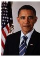 Barack Obama poses formally in a suit, with an American flag background, showcasing his presidential demeanor.