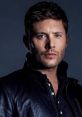 Jensen Ackles poses confidently in a stylish leather jacket, showcasing his captivating features and intense gaze.