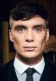 Close-up of Tommy Shelby, showcasing intense blue eyes and sharp features, embodying the character's strong presence.