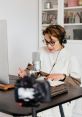 Voiceover artist recording narration with microphone and camera, creating content for "Hunter x Hunter" and "Lil Yoda.