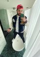 BigJigglyPanda poses playfully in a stylish jacket, balancing on a bathtub in a modern bathroom setting.