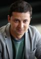 Vladimir Zelensky smiling in a casual outfit, showcasing his approachable personality and charisma.