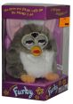 Furby toy from 1998 with playful design and interactive features in original packaging, promising endless fun and surprises.