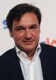Fabio Caressa, renowned Italian commentator, poses confidently at an event, showcasing his professional elegance.
