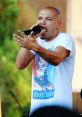Puya passionately performing on stage, showcasing his unique style in Romanian hip-hop culture.