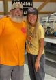 Haliey Welch poses with a friend wearing a "Hawk Tuah 24" cap, showcasing a casual and friendly atmosphere.