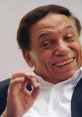Adel Emam smiling, showcasing his charismatic personality and charm, capturing the essence of Egyptian cinema.