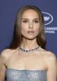 Natalie Portman at a glamorous event, showcasing her elegant style with a sequined dress and stunning necklace.