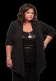 Abby Lee Miller striking a confident pose in a black outfit, showcasing her signature style and charisma in dance.
