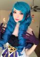Emiru cosplay featuring vibrant blue hair, striking eyes, and elegant gloves, embodying the character's unique style.