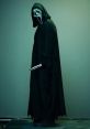 GhostFace stands ominously in a dark cloak, gripping a knife, embodying the essence of horror and suspense.