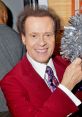 Richard Simmons smiles brightly while holding a festive pom-pom, showcasing his vibrant personality and passion for fitness.