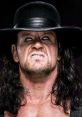WWE Undertaker with intense expression, wearing a black hat, showcasing his iconic persona in professional wrestling.
