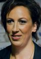 Close-up of Miranda Hart smiling confidently, showcasing her distinctive hairstyle and engaging expression at an event.