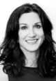 Karen K. smiling in a professional headshot, showcasing her long dark hair and confident demeanor.