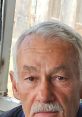 Close-up of an older man with gray hair and a mustache, conveying a thoughtful expression, possibly related to Deedo (The Recaller) 4.