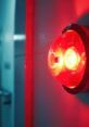 Red intercom signal light indicating important vocal tone messages in a secure environment. Essential for communication alerts.