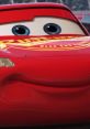 Close-up of Lightning McQueen, the iconic red race car from the movie "Cars," featuring big blue eyes and a friendly smile.