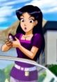 Mandy from Totally Spies! shows surprise while examining a gadget outside in a vibrant, animated scene.
