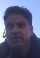 Individual with a headset appearing frustrated, captured in a moment of intensity against a clear sky backdrop.