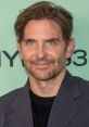 Bradley Cooper smiles confidently at a recent event, showcasing his signature style and charismatic presence.