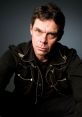 Rich Hall Richard Travis Hall (born June 10, 1954) is an American comedian, writer, director, actor and ian, first coming to