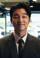 Smiling recruiter in a suit, representing Fromuid Games, stands confidently in a modern office environment.