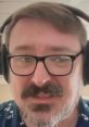 Host of The Lunduke Journal wearing headphones, speaking intently with a thoughtful expression.