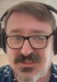 Man with headset and glasses, smiling, in a casual floral shirt, embodying the spirit of The Lunduke Journal's confrontational style.