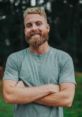 Smiling man with a beard in a green shirt, showcasing a friendly vibe related to VlogCreations content.
