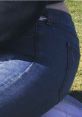 Close-up of blue jeans worn by Danielle Jauregi, showcasing a stylish casual look against a green outdoor background.