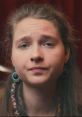 Portrait of a young woman with earrings, showcasing an expressive look, reflecting emotions related to Sina-Drums.