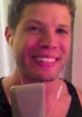 Buddy Rubino smiling while singing into a microphone with headphones on, showcasing his passion for music.