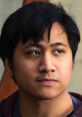 Kevin Paculan engaged in conversation, displaying a thoughtful expression and attentive gaze, in a casual setting.