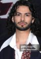 Xolo Mariduena at a red carpet event, showcasing his signature style and charm related to his role in Blue Beetle.