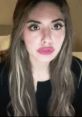 Young woman with long hair and bold makeup, focused expression, showcasing Tessi IP2 aesthetic.