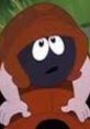 Bark McIver from "South Park," expressing curiosity with large eyes and a brown hood, surrounded by greenery.