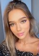 Stylish portrait of a young woman with glamorous makeup and soft waves, embodying elegance and beauty trends.