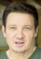 Close-up of Jeremy Renner, showcasing his thoughtful expression and distinctive features in a casual setting.