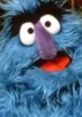 Herry Monster from Sesame Street, with vibrant blue fur and cheerful expression, spreading joy and laughter to children.