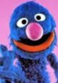 Cheerful Grover from Sesame Street with blue fur, big eyes, and a pink nose, showcasing his playful personality.