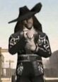 Mr. Kelley in a black cowboy outfit and wide-brimmed hat, stands confidently against a dusty Western backdrop.