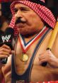 The Iron Sheik wearing a championship medal, holding a microphone, highlights his iconic wrestling persona in WWE.