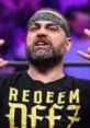 Eddie Kingston passionately gestures while wearing a "REDEEM" t-shirt, showcasing his intense persona in wrestling.