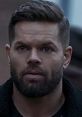 Amos Burton with a focused expression, showcasing his rugged look from The Expanse, embodying strength and resilience.