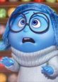 Sadness character from Inside Out, expressing concern, showcases her iconic blue tone and oversized glasses in a cozy sweater.