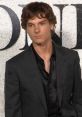 Mason Thames at a high-profile event, showcasing stylish attire and confident demeanor, exuding youthful charm.